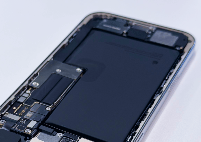 The inside of an opened iPhone, with the battery in view